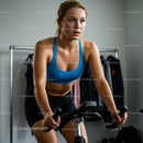 Focused Woman Engaging in Intense Indoor Cycling Workout