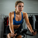 Focused Woman on Indoor Exercise Bike in Gym