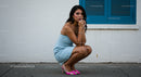 Stylish Woman in Blue Dress and Pink Heels by Urban Wall