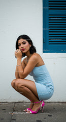 Stylish Woman in Sky Blue Dress and Pink Heels by Blue Shutters