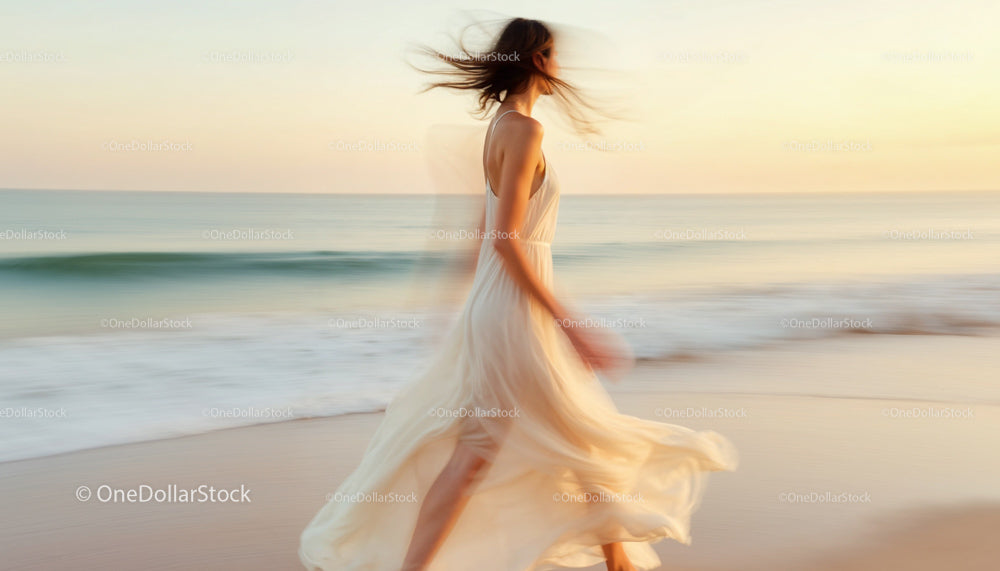 Elegant Woman in Flowing Dress at Sunset Beach