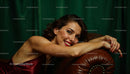Elegant Woman Relaxing on Leather Sofa in Luxurious Setting