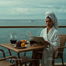 Woman in Bathrobe Enjoying Breakfast on Oceanfront Balcony