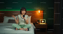 Young Woman Recording Podcast in Cozy Bedroom Setting