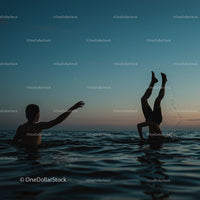 Silhouetted Figures Playing in Ocean at Sunset