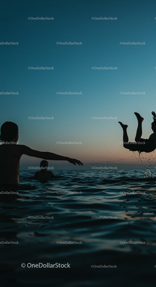 Silhouetted Friends Enjoying a Sunset Swim Adventure