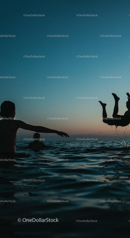 Silhouetted Friends Enjoying a Sunset Swim Adventure