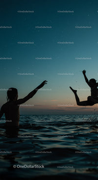 Silhouetted Figures Enjoying a Sunset Swim in the Ocean