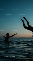 Playful Swim at Sunset with Vibrant Ocean Waves