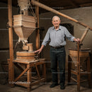 Elderly Man in Traditional Wooden Mill Workshop