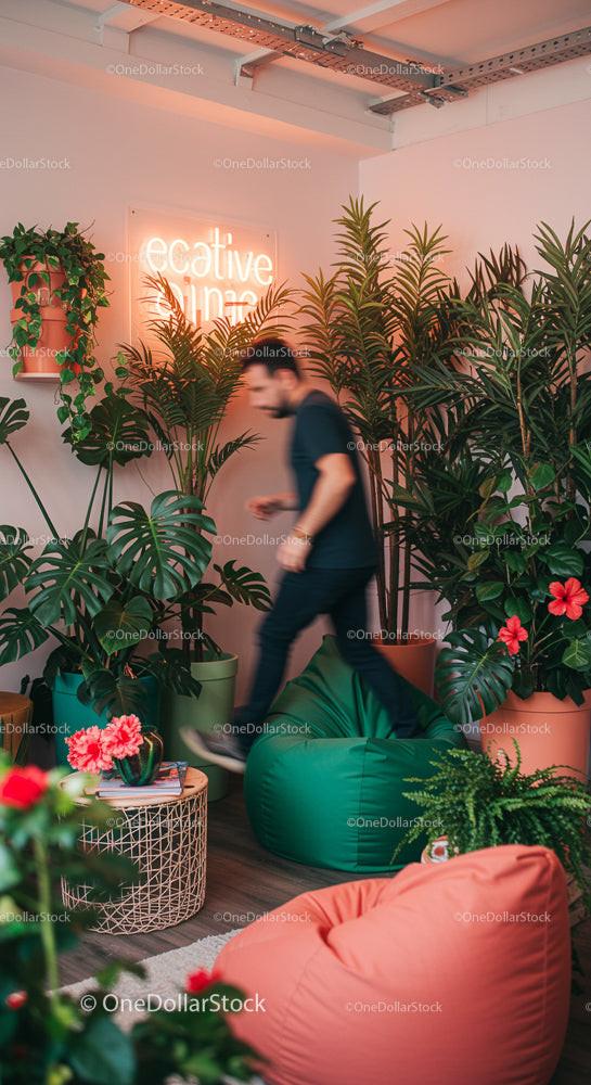 Man in Creative Office Surrounded by Lush Greenery
