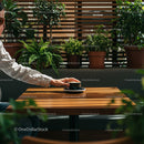 Hand Reaching for Coffee Amidst Lush Indoor Plants