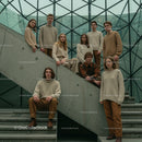Group of Young Adults in Neutral Attire on Concrete Stairs