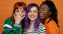 Three Joyful Women Sharing Laughter in Colorful Fashion