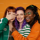 Joyful Friends Laughing Together Against Orange Backdrop