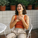 Laughing Woman in Orange Top at Outdoor Cafe