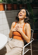 Laughing Woman Enjoying Sunlight in Patio Setting