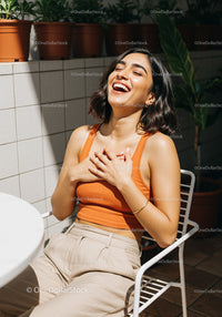Laughing Woman Enjoying Sunlight in Patio Setting