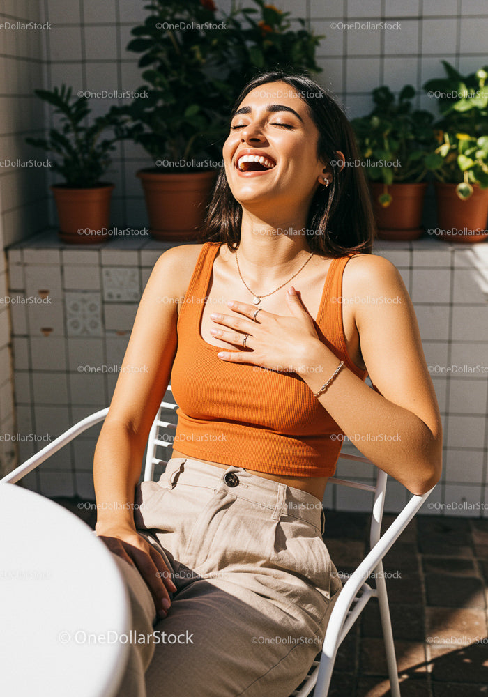 Joyful Woman in Orange Tank Top Enjoying Sunlight