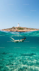 Snorkeler Exploring by Lighthouse Island in Turquoise Waters