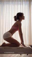 Woman Practicing Yoga in Sunlit Room