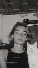 Young Woman with White Cat in Monochrome Home Setting