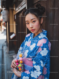Young Woman in Blue Floral Kimono with Colorful Sweets