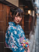 Young Woman in Floral Kimono Holding Colorful Candies