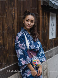 Woman in Blue Floral Kimono Holding Colorful Candies