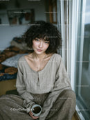 Young Woman with Curly Hair Relaxing by the Window