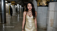 Elegant Woman in Gold Dress at Metro Station