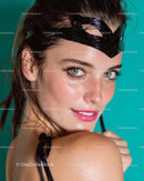 Playful Woman with Black Mask and Turquoise Background