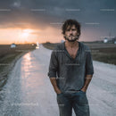 Rugged Man Walking on a Countryside Road at Sunset