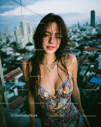 Smiling Woman in Colorful Dress on Urban Rooftop at Sunset