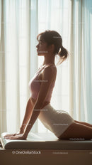 Woman Practicing Yoga in Sunlit Room