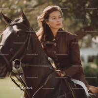 Stylish Woman in Vintage Equestrian Outfit Riding Horse