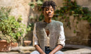 Confident Woman in Chainmail with Greenery Background