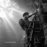 Adventurer Climbing Bamboo Ladder in Sunlit Cave