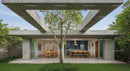 Modern Concrete Structure with Outdoor Dining and Tree Canopy