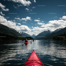 Kayakers Exploring Serene Mountain Lake Under Blue Skies