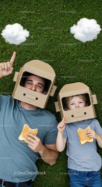 Father and Son Enjoying Imaginative Play on Grass