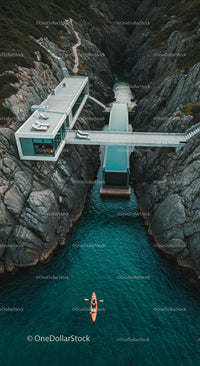 Luxury Cliffside House with Kayaker on Turquoise Waters