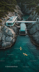 Modern Cliffside House with Kayakers in Blue Waters