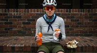 Cyclist Enjoying a Refreshing Break with Orange Soda