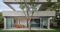 Contemporary Concrete House with Open Dining Area and Greenery