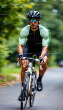 Cyclist Racing on a Scenic Forest Road in Summer