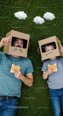 Father and Son Enjoying Playful Cardboard Adventure