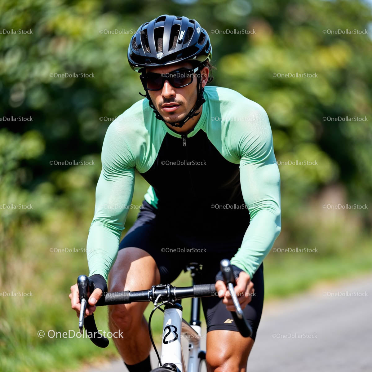 Focused Cyclist Riding on a Sunny Day in Green Jersey