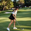 Focused Woman Playing Golf on Lush Green Course
