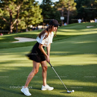 Focused Woman Playing Golf on Lush Green Course